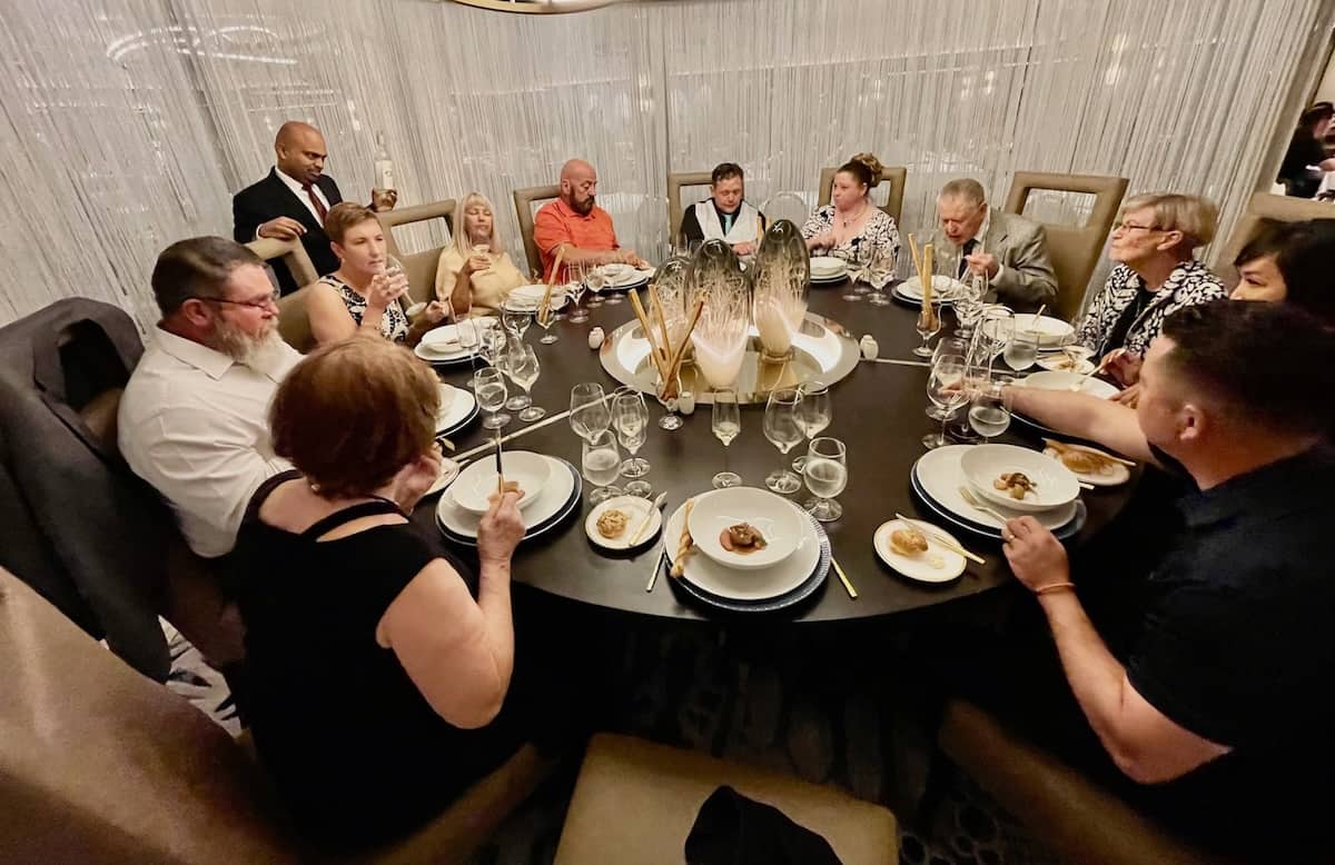 Twelve well-fed guests at the Chef’s Table Lumiere
