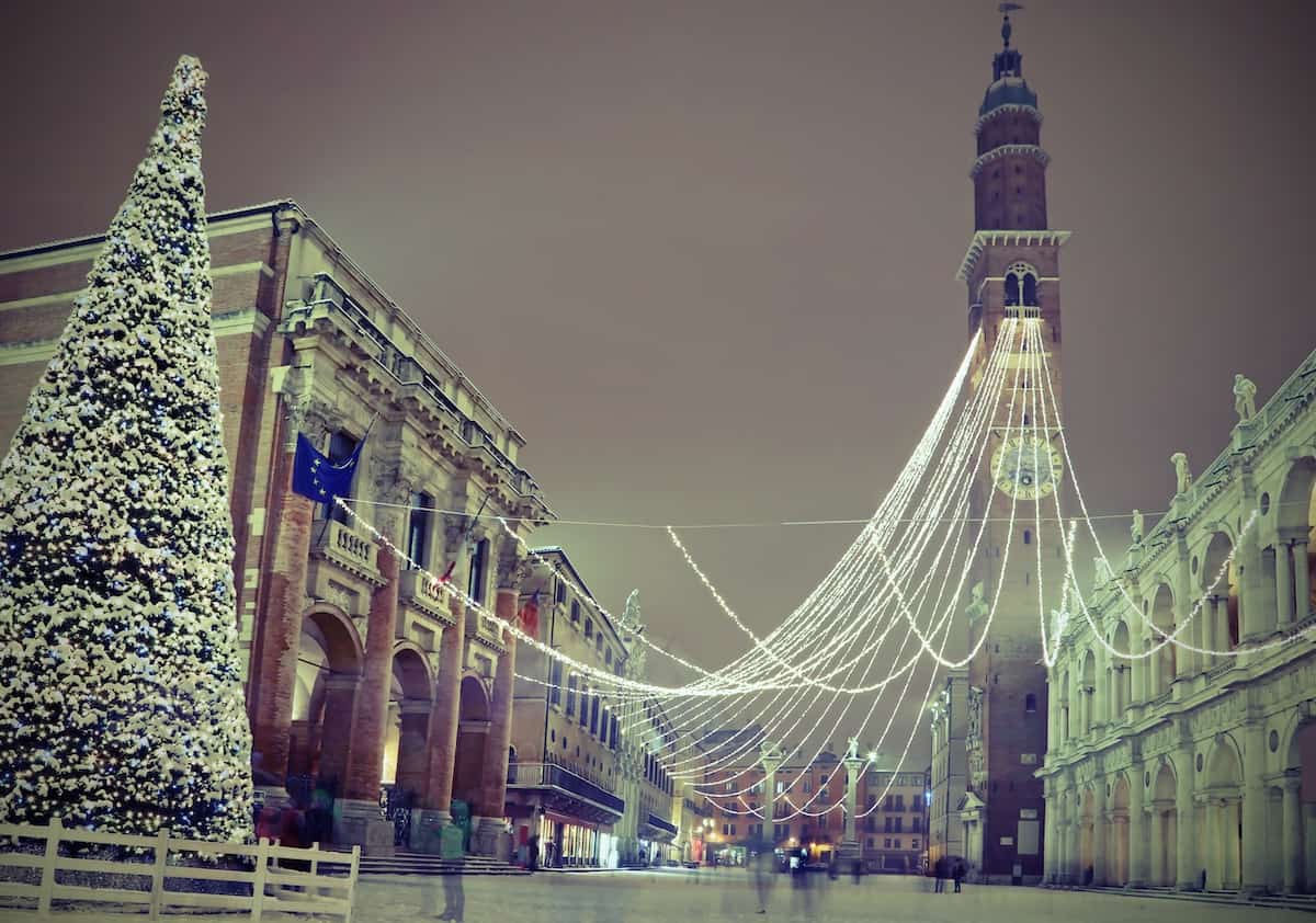 Big Christmas tree with snow in Vicenza in Northen Italy and the main monument called Basilica Palladiana with vintage effect