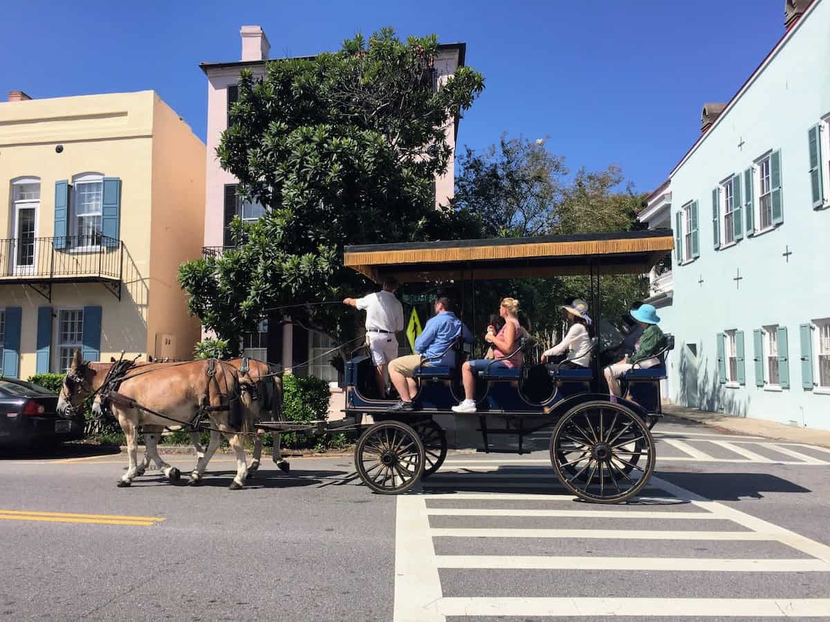 Visitors take a carriage ride through downtown Charleston