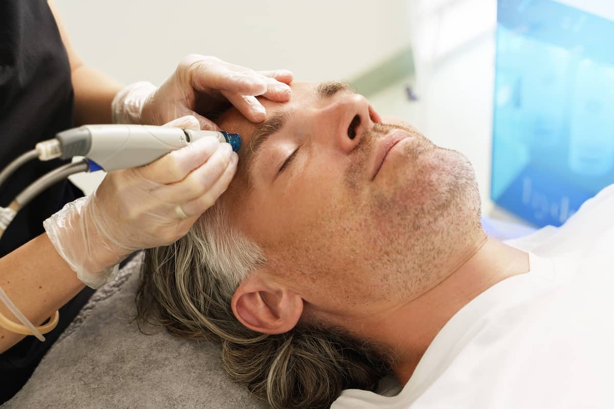 Men and Spas: Man receiving a deep facial cleansing 