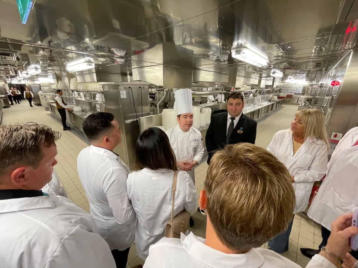 The Executive Chef guides guests through the galley prior to The Chef’s Table Lumiere