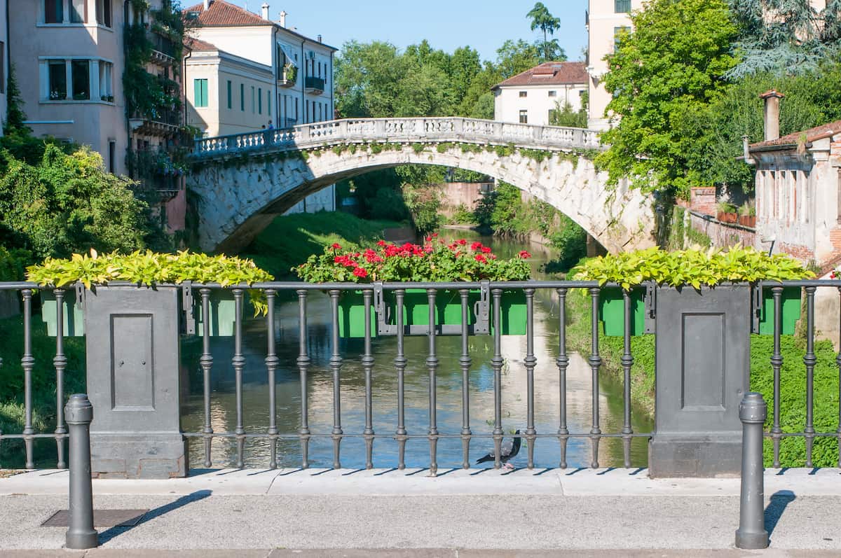 Flowered balcony of Saint Paul bridge in Vicenza, Retrone river and Saint Michele bridge in the background