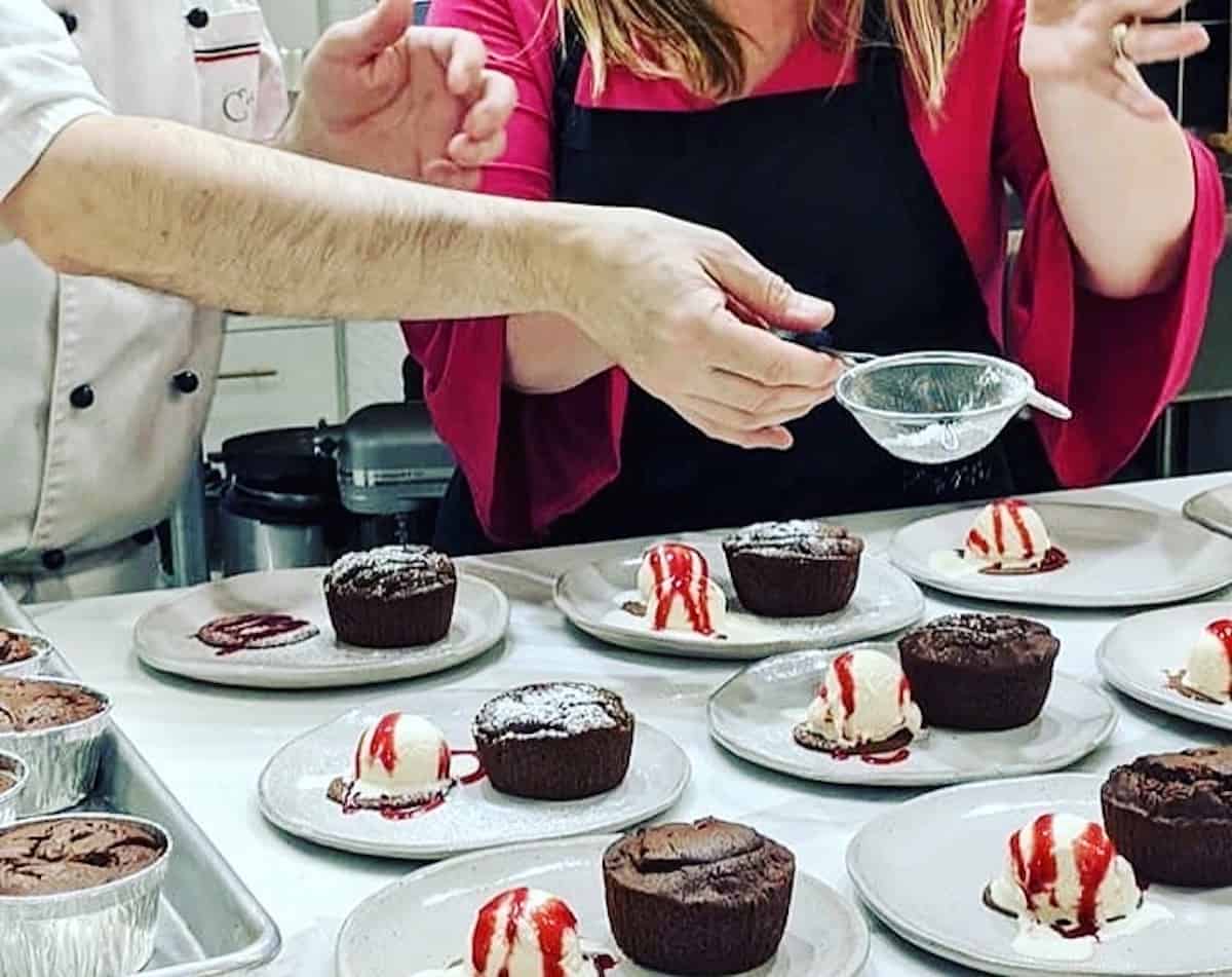 Plating hot chocolate cakes in Vincenzo's kitchen