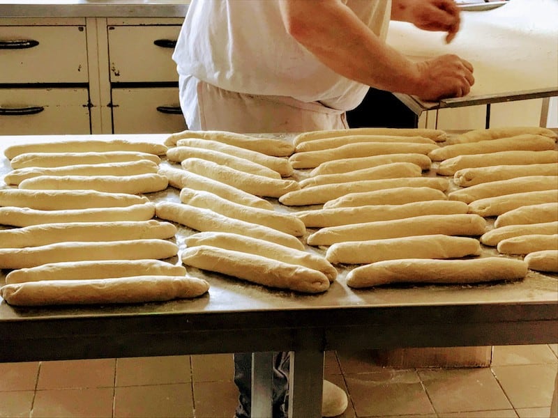 Barge Cruise Through Alsace & Lorraine - Baker at Boulangerie Ruby preparing French breads for the oven 