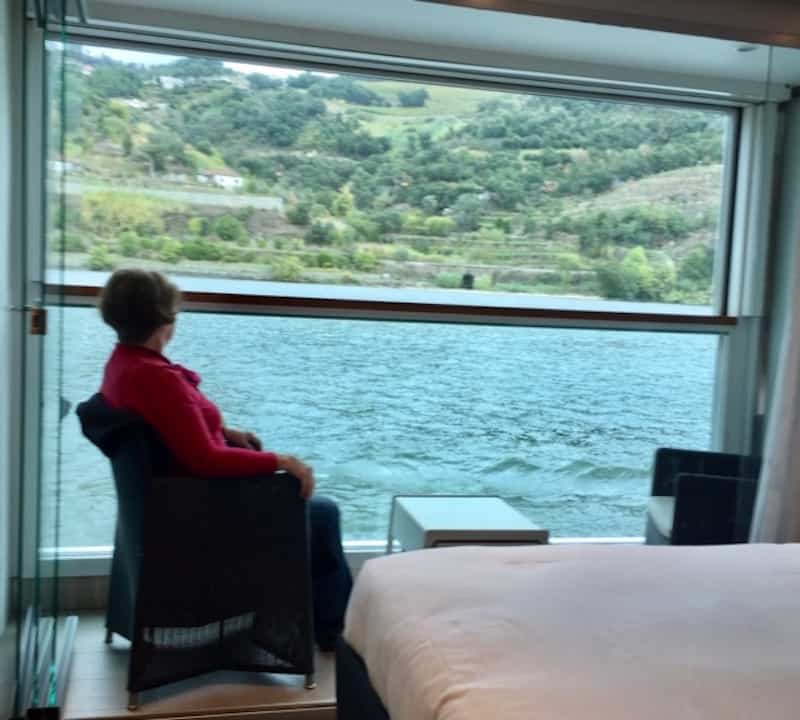 One of the authors beside the huge windows of Scenic Azure that overlook a spacious balcony