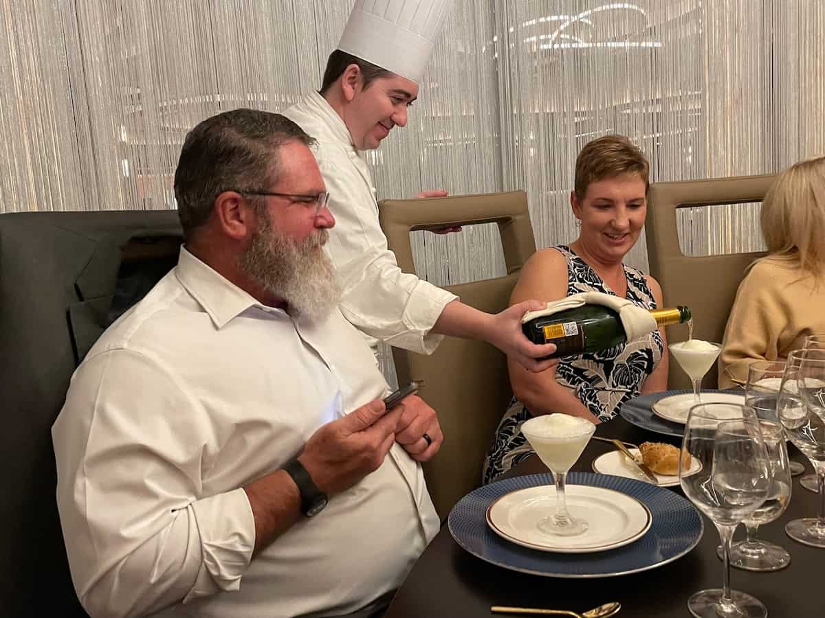 Executive Chef pours champagne over palate cleansing sorbet