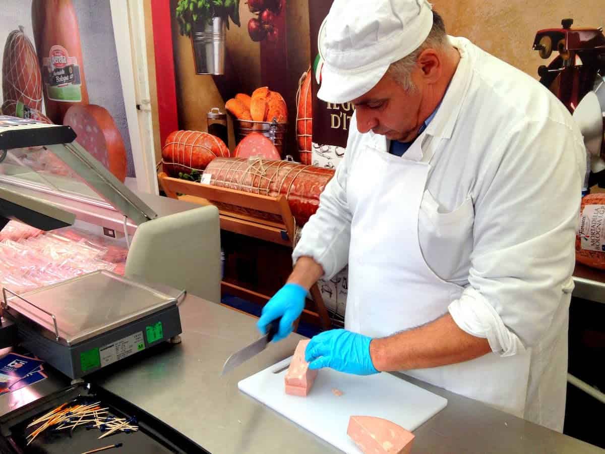 Vendor cutting juicy chunks of the delicious meat