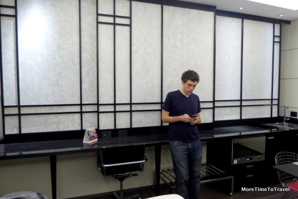 Our son beside the spacious desk area; the sliding shutters open to the outside