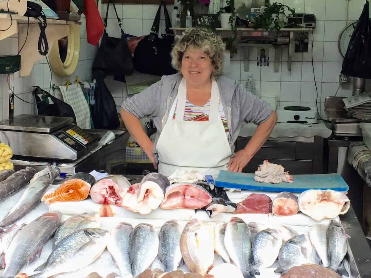 Meeting a local fish. monger in Porto, Portugal on a river cruise